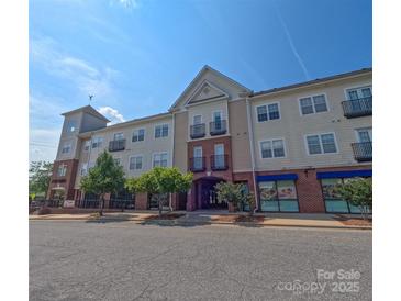 Attractive condo building with brick and siding exterior featuring balconies on a sunny day at 1410 4Th Street Nw Dr # 303, Hickory, NC 28601