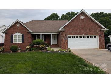Charming single-story brick home featuring an attached two-car garage and well-maintained landscaping at 1764 Pipers Ridge Nw Cir, Conover, NC 28613