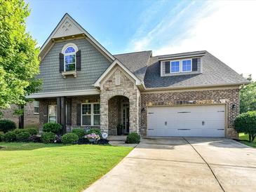 Charming brick and stone home with a well-manicured lawn and inviting front entrance at 2005 Arbor Hills Dr, Indian Trail, NC 28079