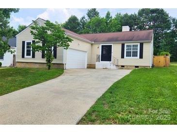 Charming one-story home featuring a long driveway, attached garage, and well-manicured lawn at 3106 Faircroft Way, Monroe, NC 28110