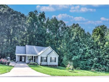 Charming single-story home with a manicured lawn, complemented by a lush, wooded backdrop at 5437 Mallard Ln, Gastonia, NC 28052