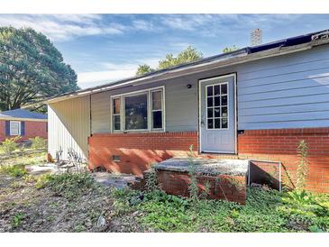 Exterior view of house with red brick foundation and white door with window panes at 112 Harmony Trl, Gastonia, NC 28056
