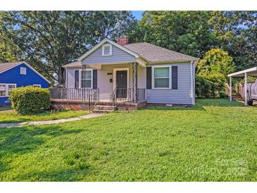 Charming one story home with an inviting porch and fresh green lawn at 2405 Greenland Ave, Charlotte, NC 28208