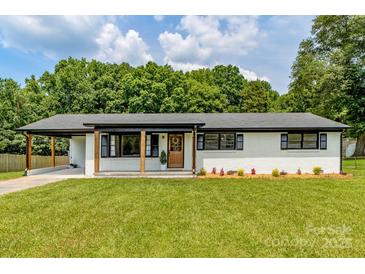 Charming, renovated ranch home with a lovely, welcoming front yard and a brick exterior at 2610 Fairgreen Dr, Gastonia, NC 28056