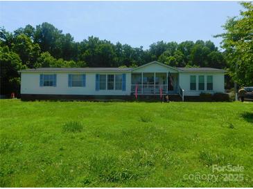 Charming single-Gathering home features a covered porch and well-maintained lawn at 33343 Old Salisbury Rd, Albemarle, NC 28001