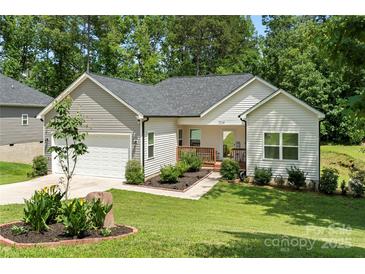Charming single Gathering home with a well-manicured lawn, tidy landscaping, and welcoming front porch at 7516 O'Hara St, Huntersville, NC 28078