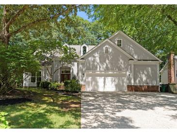 Traditional home with neutral siding, attached two-car garage, and mature landscaping at 9141 Covey Hollow Ct, Charlotte, NC 28210