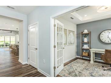 Bright home office with open doorway, french doors, wood floors, gray accent wall and white trim at 1022 Kinship Dr # 118, Lancaster, SC 29720