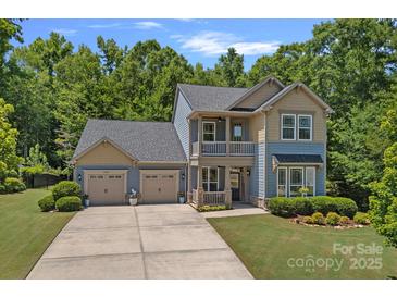 Charming two-story home with a spacious three-car garage and beautifully landscaped front yard at 1209 Shelly Woods Dr, Indian Land, SC 29707