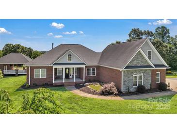 Beautiful brick home with a well-manicured lawn and inviting front porch, exuding curb appeal and charm at 2145 Jack Wilson Rd, Shelby, NC 28150