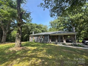Charming single-story home with a stone front porch and large, shaded front yard at 6616 Love Mill Rd, Monroe, NC 28110