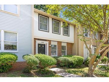 Traditional multi-level home showcasing manicured landscaping and a classic front entrance at 8266 Knights Bridge Rd, Charlotte, NC 28210