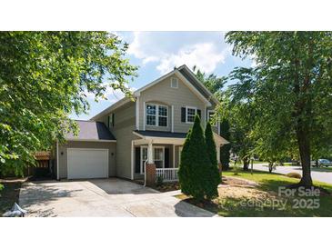 Charming two-story home with a well-manicured lawn, attached garage, and inviting front porch at 8343 Highlander Ct, Charlotte, NC 28269