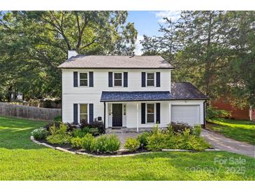 Charming two-story home with white siding, black shutters, and a well-manicured front yard at 11401 Lone Star Cir, Charlotte, NC 28226