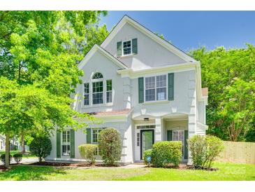 Charming two-story home with bright green shutters and lush landscaping, well maintained at 2830 Grosbeak Ln, Charlotte, NC 28269