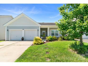 Charming single-story home with a manicured lawn, two-car garage, and inviting front porch at 3296 Saddlebrook Dr, Midland, NC 28107