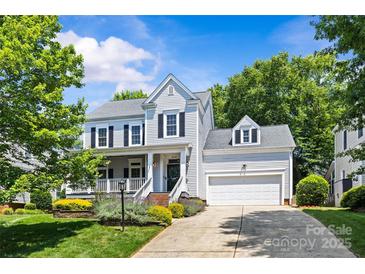 Charming two-story home featuring a well-manicured lawn, attached garage, and inviting curb appeal at 3535 Selwyn Farms Ln, Charlotte, NC 28209