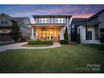 Inviting two-story home featuring a spacious front porch, manicured lawn, and a blend of traditional and modern design elements at 508 Mcalway Rd, Charlotte, NC 28211