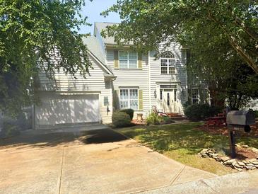 Charming two-story home with a well-manicured lawn, light siding, a two-car garage, and a welcoming front entrance at 6311 Red Maple Dr, Charlotte, NC 28277