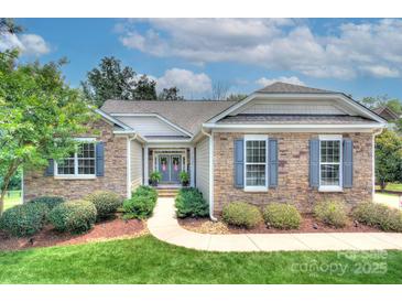 Charming stone home with manicured landscaping, inviting entrance, and beautiful curb appeal at 6326 Jepson Ct, Charlotte, NC 28214