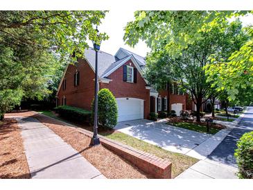 Charming brick home with well-manicured landscaping and a two-car garage at 7554 Bluestar Ln, Charlotte, NC 28226