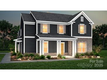 Charming two-story home with a brick-accented front and a welcoming covered porch at 9520 Coast Laurel Nw Ave, Concord, NC 28027
