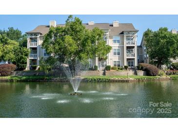 Stunning multi-story condo complex overlooking a tranquil lake with a fountain at 18730 Nautical Dr # 102, Cornelius, NC 28031
