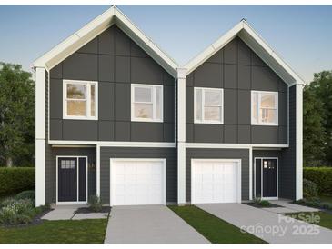 Modern two-story townhomes with clean lines, dark siding, and white trim at 3719 Davis Ave, Charlotte, NC 28208