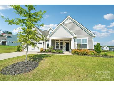 Charming single-Gathering home with manicured lawn, two-car garage, covered entrance, and beautiful landscaping at 507 Yucatan Dr # 71, Waxhaw, NC 28173