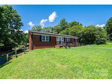 Charming brick home with lush green lawn and black shuttered windows at 559 15Th Se Ave, Hickory, NC 28602