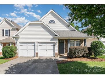 Charming home features a two-car garage, stone accents, and a well-maintained front yard and lovely curb appeal at 9644 Marquette Nw St, Concord, NC 28027