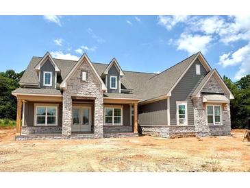 A single-story home featuring board and batten siding, stone accents and a gable roof at 137 Crestview Ln # 16, Troutman, NC 28166