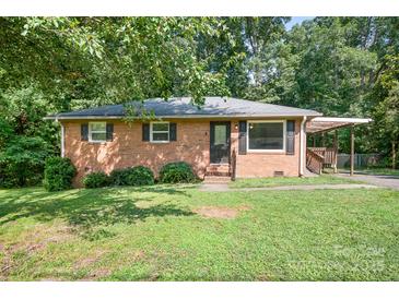 Charming single-story brick home with black shutters, a pergola, and a well-maintained lawn at 408 Kennerly Dr, Indian Trail, NC 28079