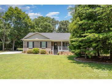 Charming brick ranch-style home with well-manicured lawn and inviting front porch at 551 Sand Trap Dr, York, SC 29745