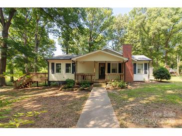 Charming single-story home with inviting front porch, brick chimney, and walkway, surrounded by mature trees at 6115 Campbell Rd, York, SC 29745