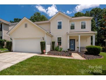 Charming two-story home with a well-manicured lawn and inviting front porch perfect for a Gathering at 6422 Gatesville Ln, Charlotte, NC 28270