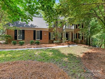 Charming two-story brick home with a well-maintained lawn and mature trees at 10333 Scott Gate Ct, Charlotte, NC 28277