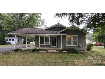 Charming single-story home featuring a covered porch, brick facade, and well-maintained landscaping at 1521 N Piedmont Ave, Kings Mountain, NC 28086