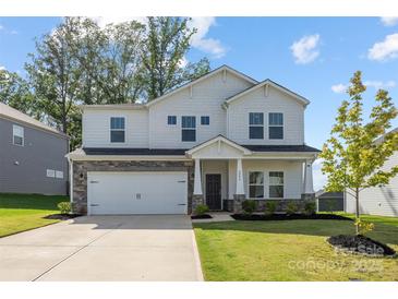 Charming two-story home with stone accents, well-manicured lawn, and a two-car garage at 4046 Armstrong Farm Dr, Belmont, NC 28012