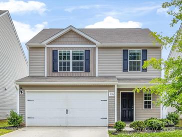Charming two-story home with a two car garage, landscaped yard, and neutral siding at 9136 Creedmore Hills Dr, Charlotte, NC 28214