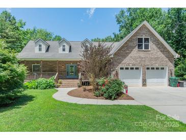 Charming brick home with a well-manicured lawn and an inviting covered porch at 260 River Country Rd, Salisbury, NC 28146