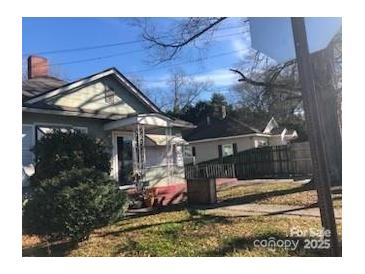 Modest bungalow-style home with mature landscaping and inviting front porch at 410 Arthur Ave, Gastonia, NC 28052