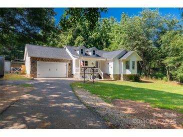 Charming home featuring a stone-accented garage and a well-manicured lawn at 4567 Hickory Grove Rd, Sharon, SC 29742
