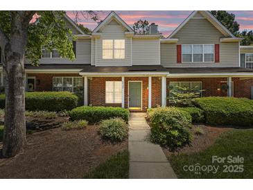 Charming townhome with brick facade, manicured landscaping, and inviting front porch at 5724 Cougar Ln, Charlotte, NC 28269