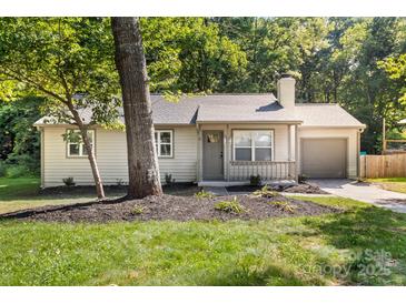 Charming single-story home featuring a cozy front porch, landscaped yard and a one car garage at 6515 Santa Cruz Trl, Charlotte, NC 28227