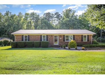 Charming brick home with a well-maintained lawn and manicured hedges in a serene setting at 753 Briarfield Rd, Rock Hill, SC 29730