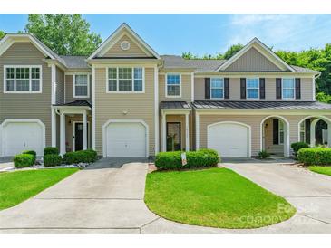Charming townhouse with a well-manicured lawn, attached garages, and neutral siding for a welcoming curb appeal at 14755 Lions Paw St, Charlotte, NC 28273