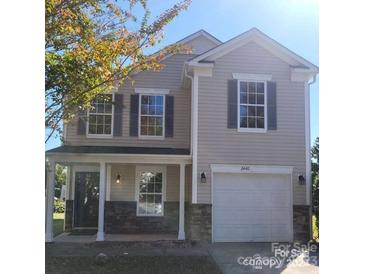 Charming two-story home featuring a covered porch and a two-car garage at 2440 Mint Thistle Ct, Charlotte, NC 28269