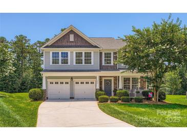 Charming two-story home with a well-manicured lawn, a two-car garage, and a welcoming front porch at 2630 Filson Ct, Charlotte, NC 28214