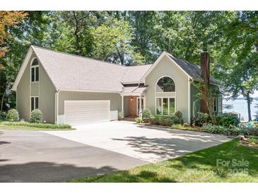 Inviting home with a two-car garage, beautiful landscaping, and a spacious driveway perfect for outdoor living at 2704 Apache Trl, Denver, NC 28037